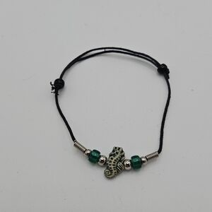 black slider bracelet with green and cream seahorse bead